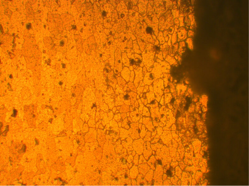 Fig 1. Intergranular attack and the formation of a corrosion pit at the surface of aluminium - Aerofin Laboratories Ltd